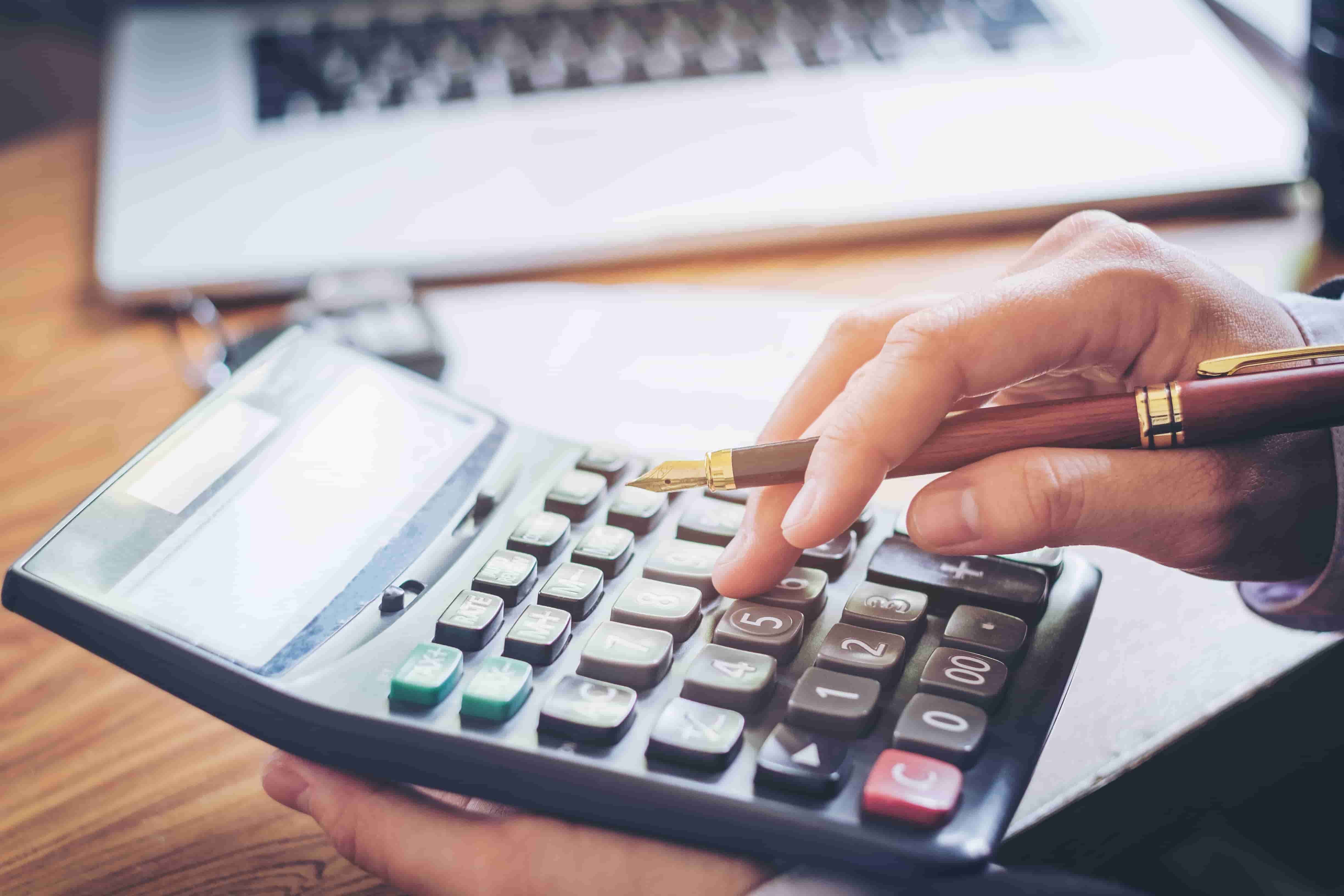 Une femme tapant sur une calculette